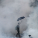 A protester walks in tear gas fired by riot police on Sept. 28 2014.